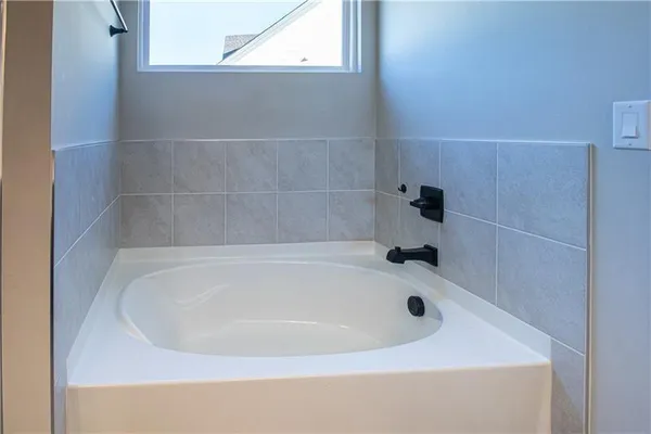 a white bath tub sitting in a bathroom