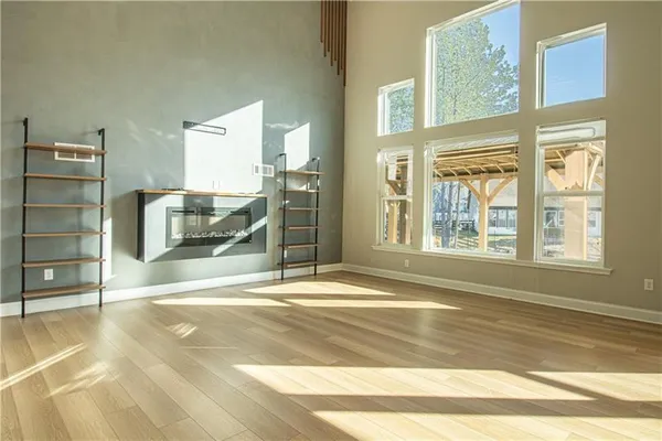 a view of empty room with cabinet and window