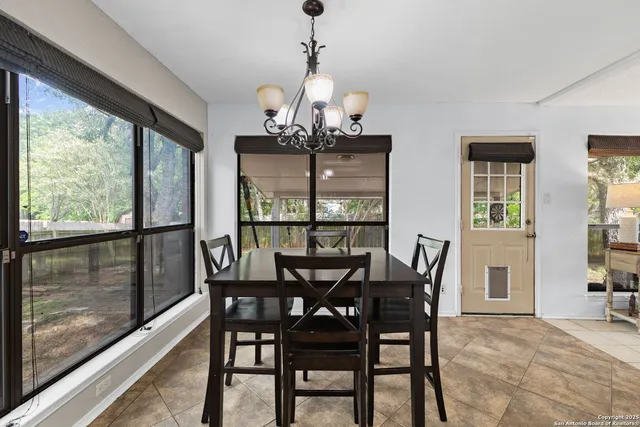 a view of a dining room with furniture large windows and wooden floor
