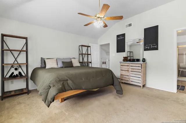 a bedroom with a bed dresser and a ceiling fan