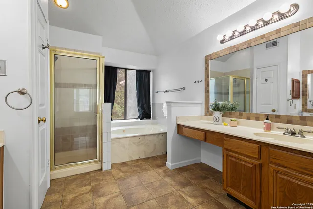 a bathroom with a tub sink and mirror