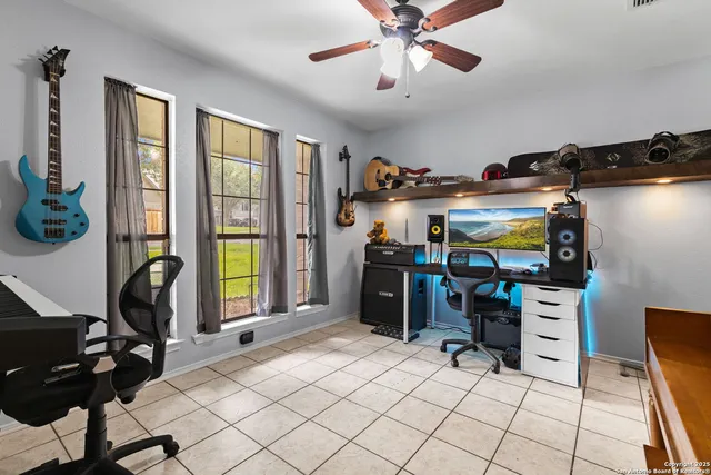 a view of a workspace with furniture and a window