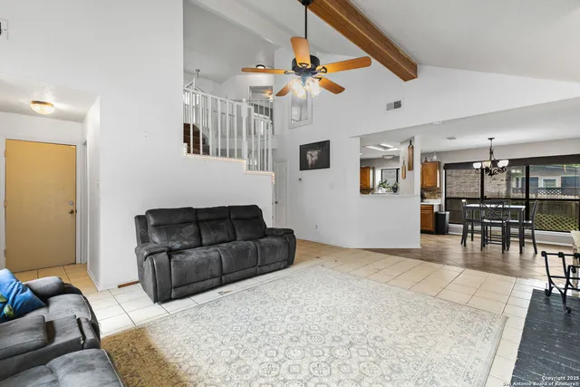 a living room with furniture and kitchen view