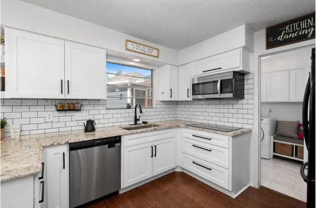 a kitchen with a sink stove and cabinets