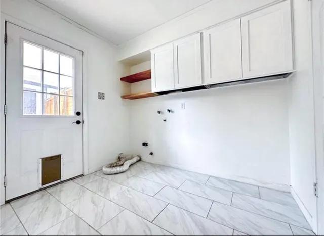 a view of kitchen with cabinets