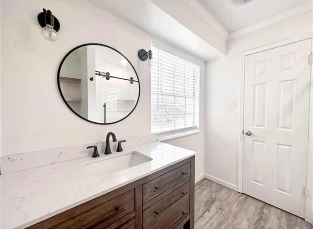 a bathroom with a sink a mirror and a shower