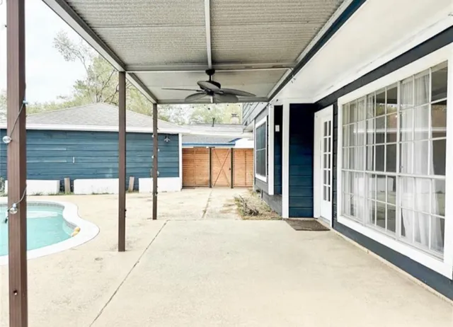 a view of a porch with a table and chairs