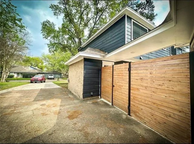 a view of garage yard and deck
