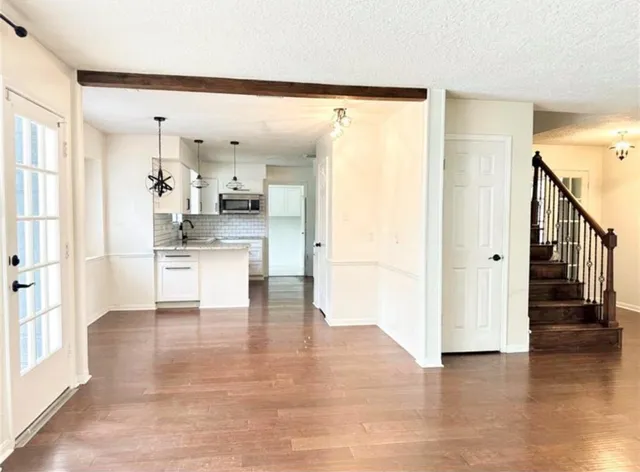 a view of a kitchen with wooden floor and a kitchen