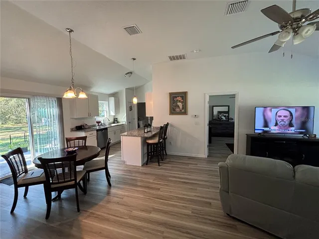 a view of a dining room with furniture window and outside view