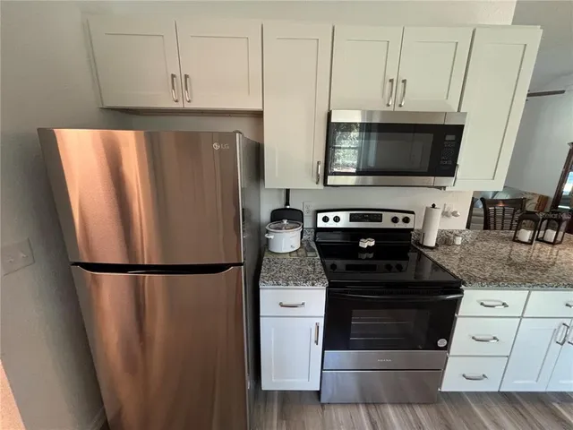 a kitchen with a refrigerator stove and microwave