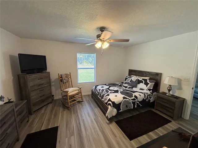 a bedroom with furniture and a tv