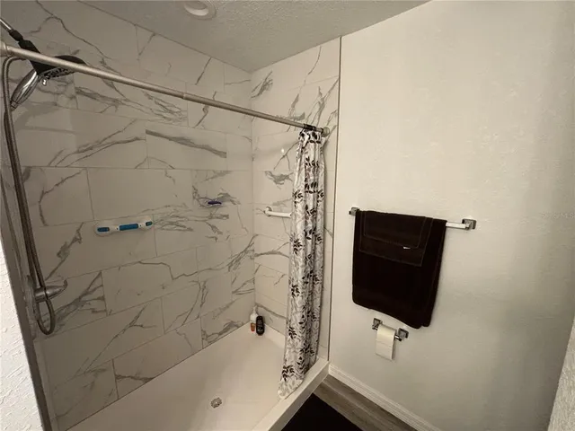 a bathroom with a shower and a bathtub