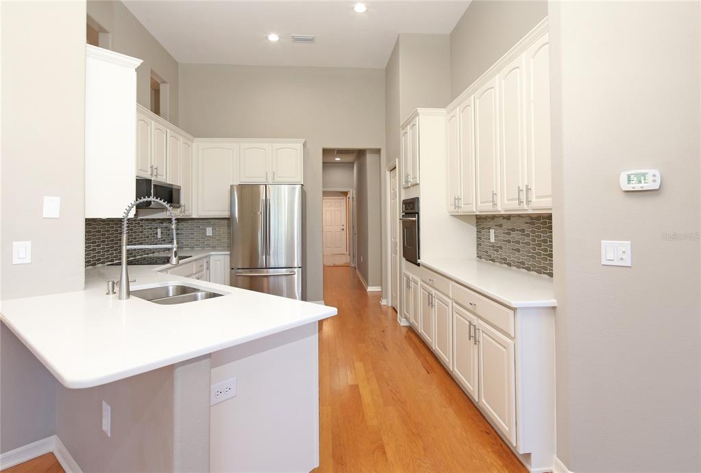 23 West Mickey Mantle Path Hernando, FL 34442 - Photo 11 of 53 a kitchen with a sink a refrigerator and a stove