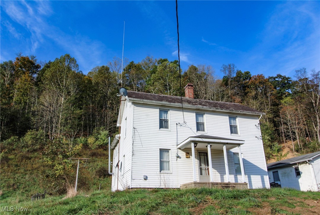 15999 State Route 26 Reno, OH 45773 - Photo 3 of 18 View of front facade featuring a chimney and a porch
