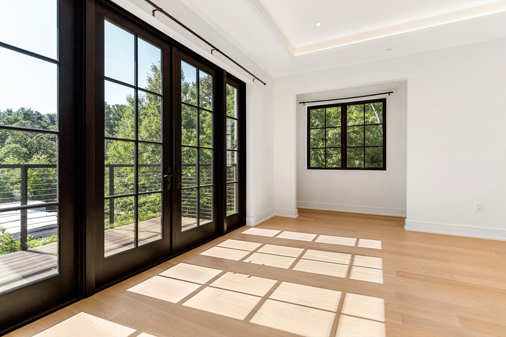 148 Weston Road, Unit 207 Wellesley, MA 02482 - Photo 17 of 25 a view of an empty room and window