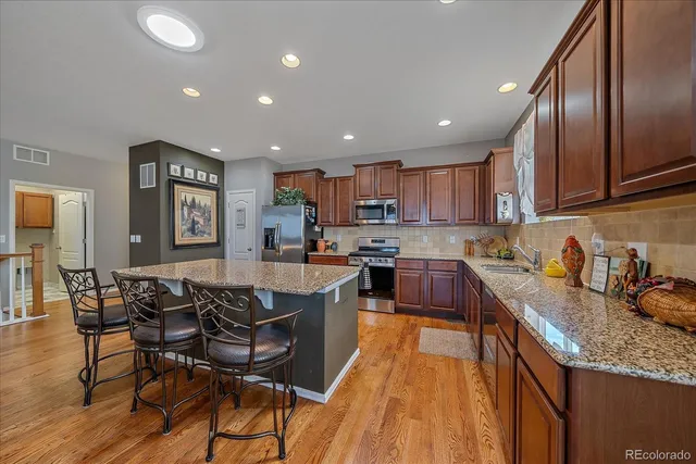 a kitchen with granite countertop lots of counter top space and stainless steel appliances