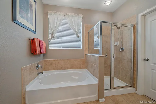 a bathroom with a tub and shower
