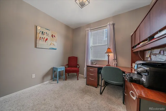 a view of a livingroom with workspace and a window