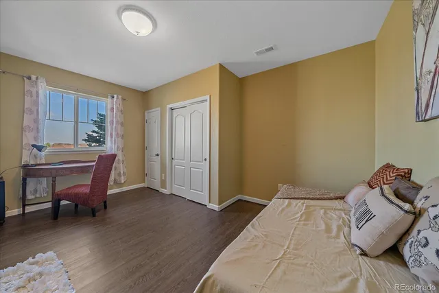 a bedroom with a bed and a table in it