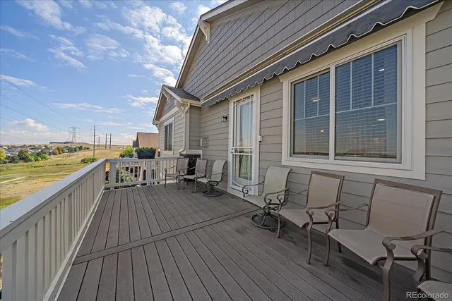 a view of a balcony with chair and wooden floor