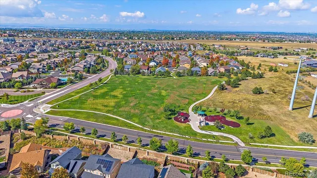 an aerial view of a house with a garden and lake view