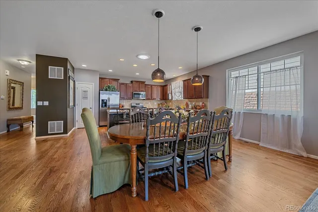 a view of a dining room with furniture window and wooden floor