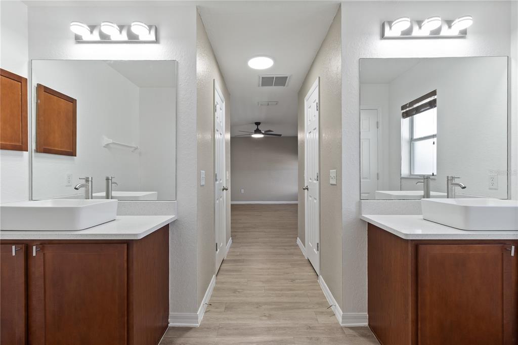 12374 Corrine Avenue Spring Hill, FL 34609 - Photo 11 of 28 a en suite bathroom with a sink double vanity and a mirror
