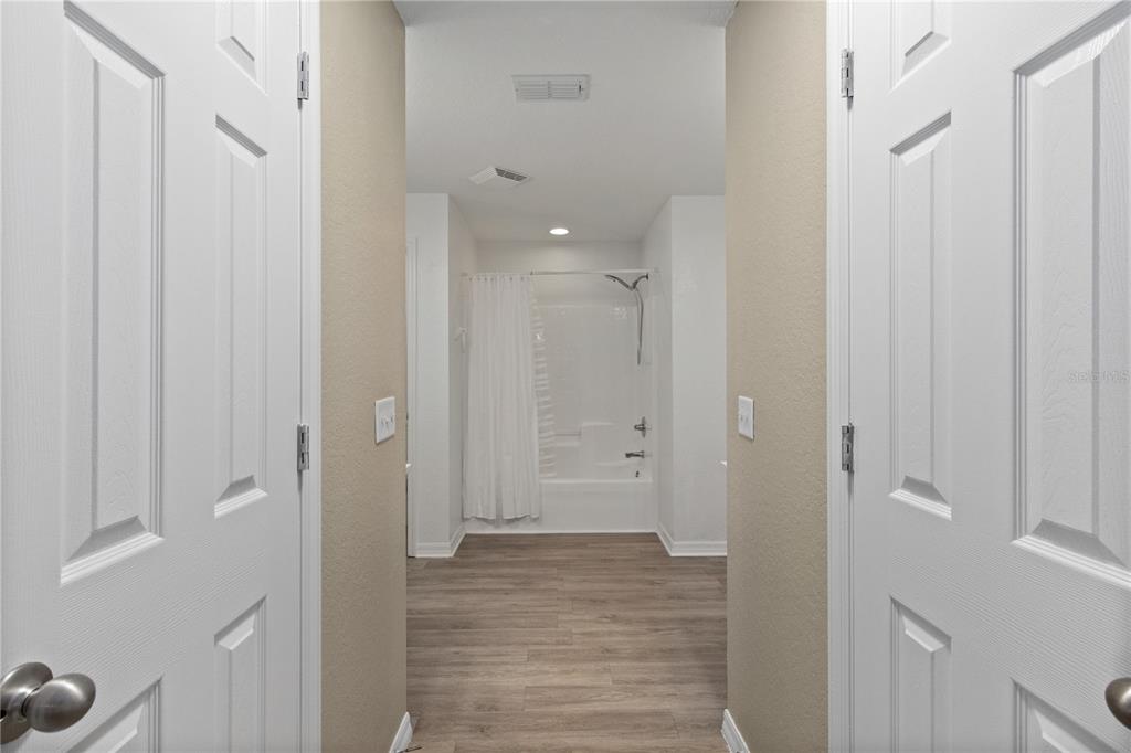 12374 Corrine Avenue Spring Hill, FL 34609 - Photo 13 of 28 a view of a hallway with wooden floor