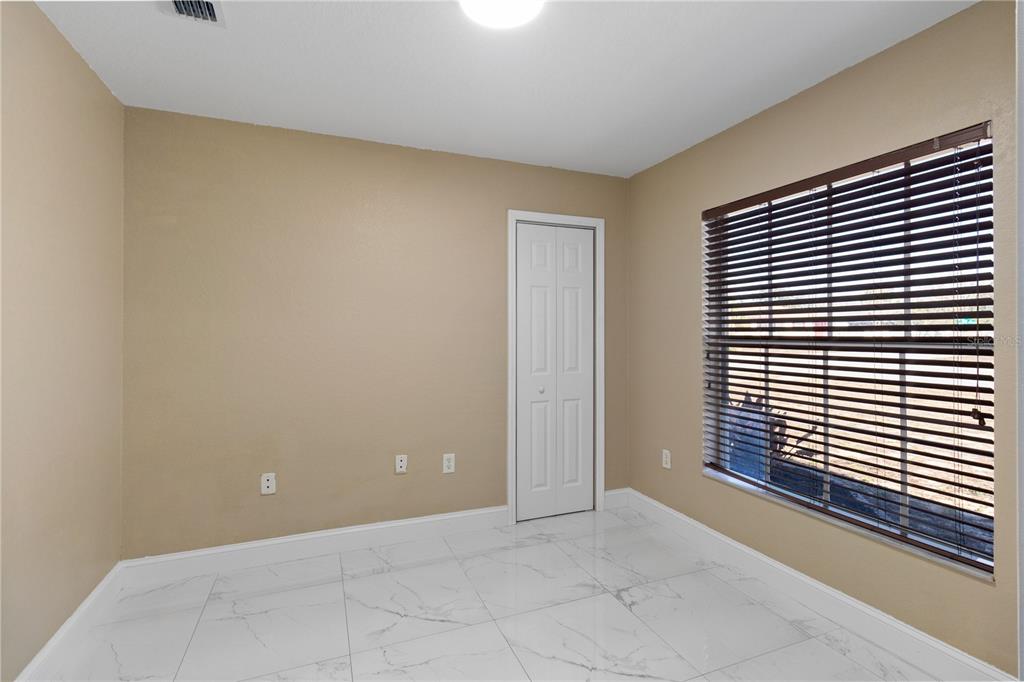 12374 Corrine Avenue Spring Hill, FL 34609 - Photo 14 of 28 a view of an empty room with wooden floor