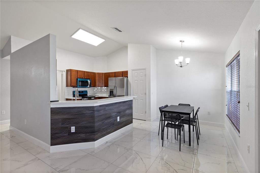 12374 Corrine Avenue Spring Hill, FL 34609 - Photo 24 of 28 a room with a table and chair in it