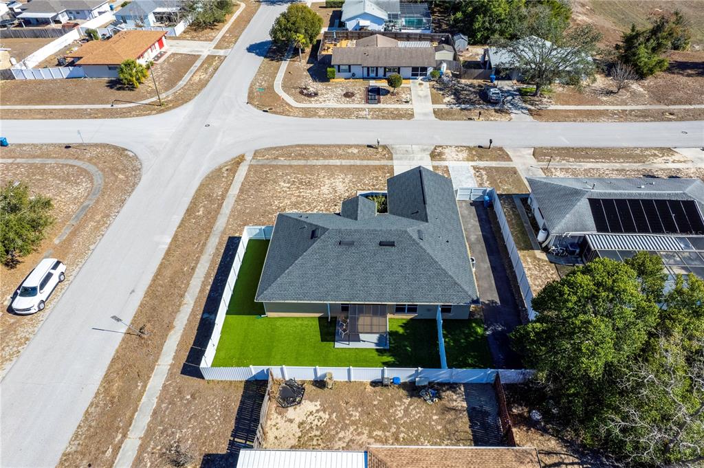 12374 Corrine Avenue Spring Hill, FL 34609 - Photo 6 of 28 an aerial view of multiple houses with yard