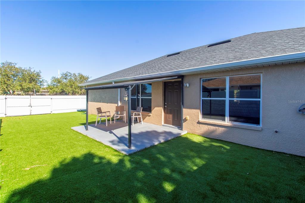 12374 Corrine Avenue Spring Hill, FL 34609 - Photo 7 of 28 a view of an house with backyard and porch