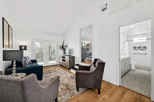 a living room with furniture wooden floor and a large window