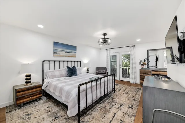 a bedroom with a bed a couch and dresser