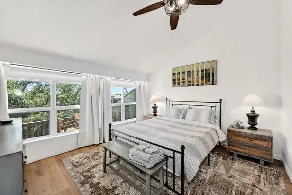 a bedroom with a bed next to a window with a book shelf