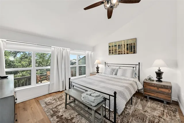 a bedroom with a bed next to a window with a book shelf