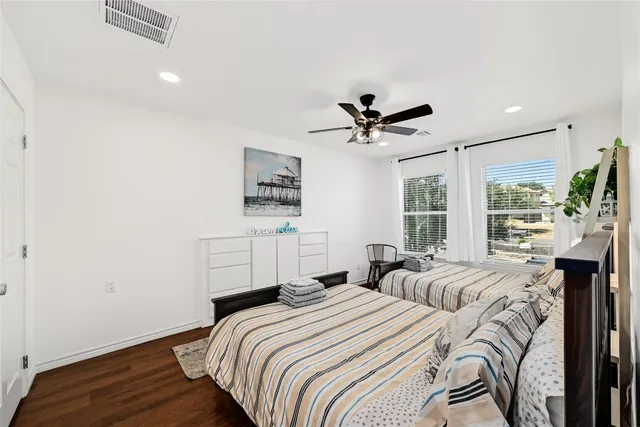 a bedroom with bed and wooden floor