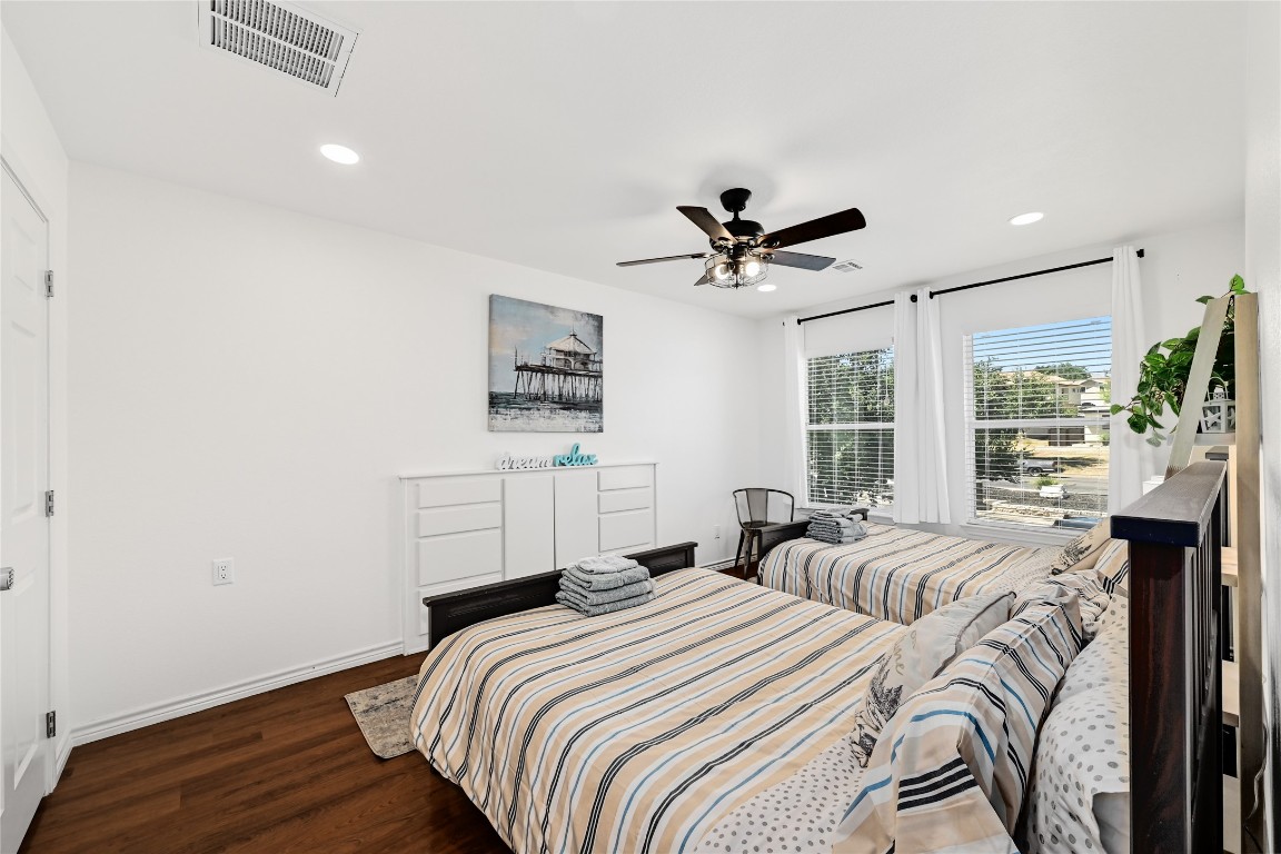 225 Comanche Lane Point Venture, TX 78645 - Photo 25 of 40 a bedroom with bed and wooden floor