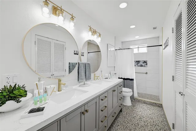 a bathroom with a sink a mirror and a potted plant