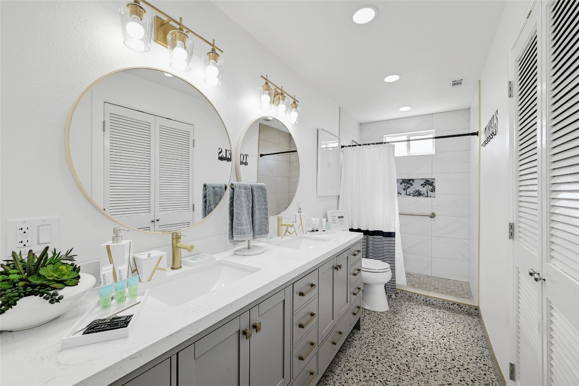 225 Comanche Lane Point Venture, TX 78645 - Photo 27 of 40 a spacious bathroom with a double vanity sink mirror and a