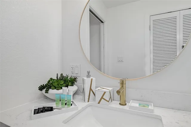 a bathroom with a sink toilet vanity and shower