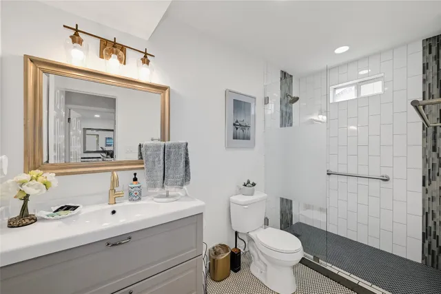 a glass vase with flowers on a shelf