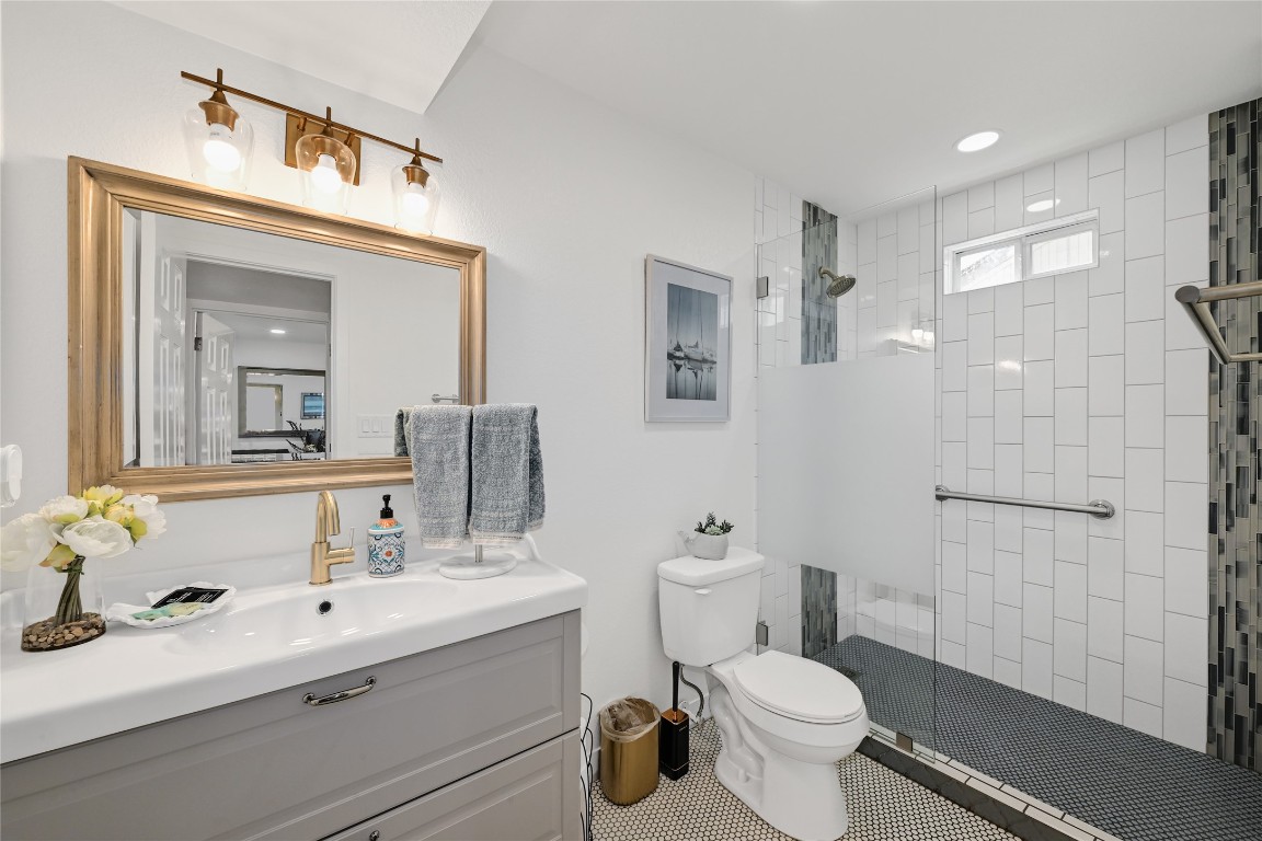 225 Comanche Lane Point Venture, TX 78645 - Photo 29 of 40 a bathroom with a sink toilet vanity and shower