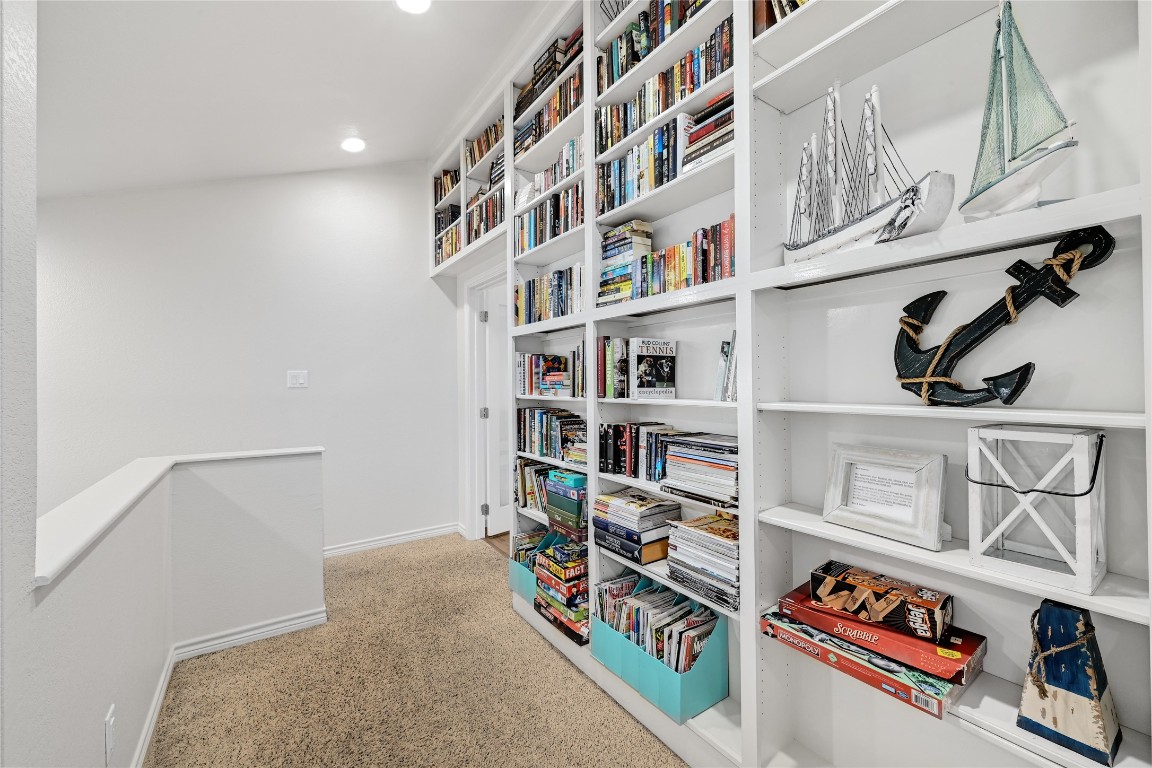 225 Comanche Lane Point Venture, TX 78645 - Photo 34 of 40 a book shelf with books and knick knacks on it