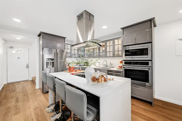 a kitchen with a sink appliances and cabinets