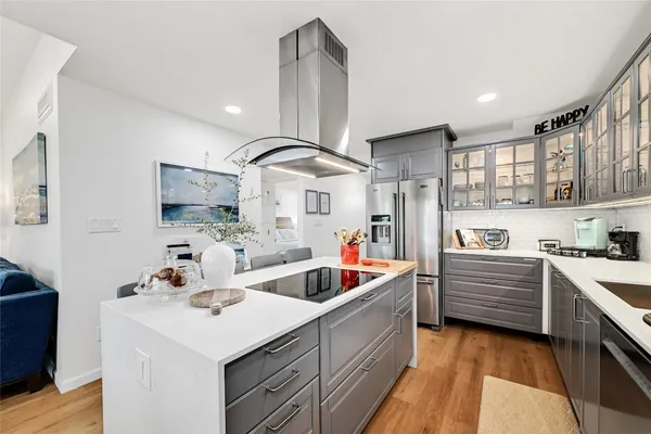 a kitchen with stainless steel appliances kitchen island granite countertop a sink and cabinets