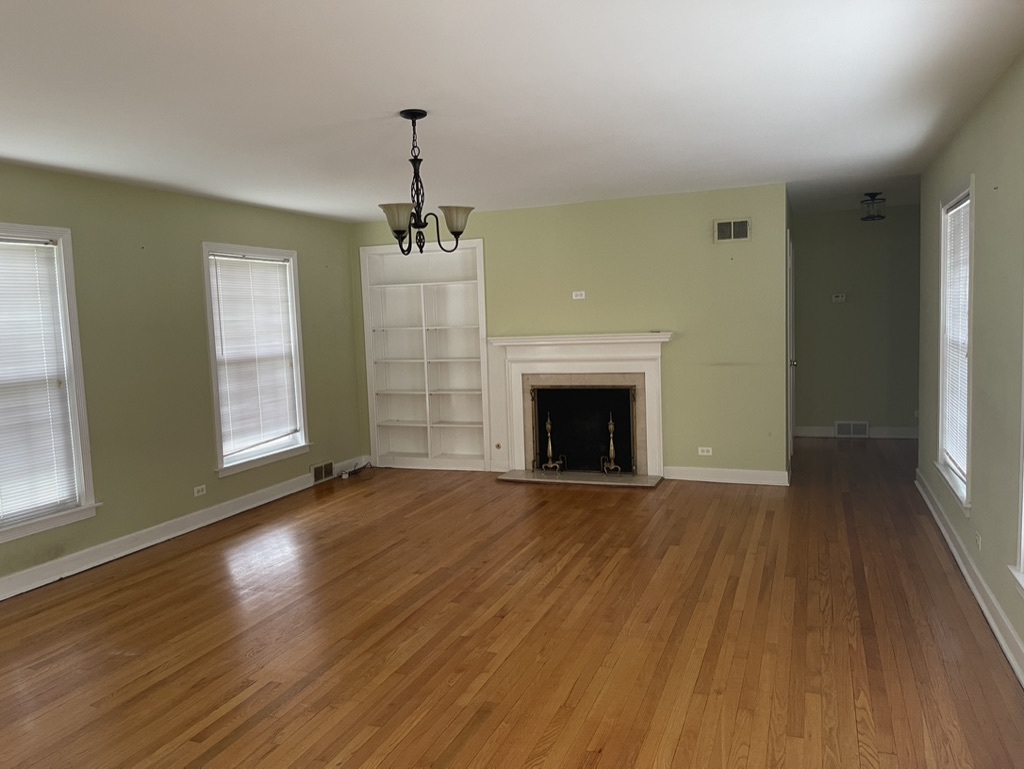 791 Braeburn Road Inverness, IL 60067 - Photo 4 of 14 a view of empty room with wooden floor and fireplace