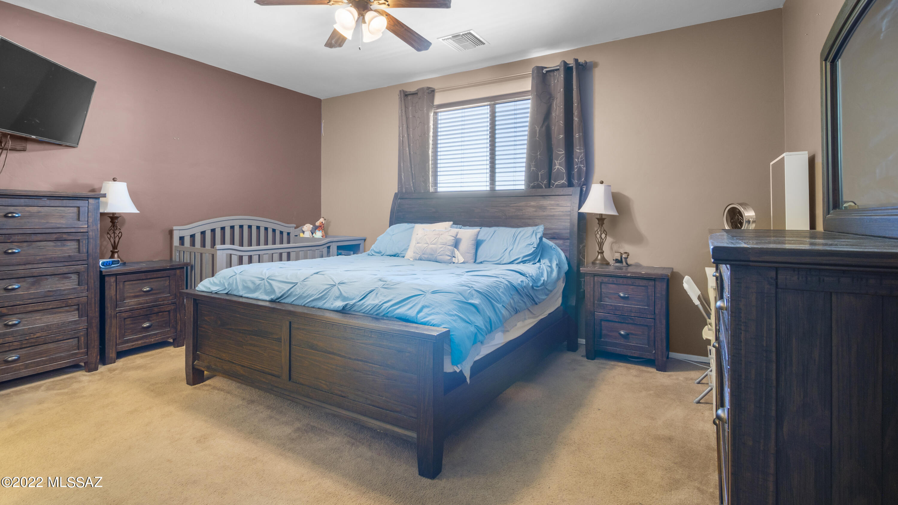 1081 Vista De Los Alamos Rio Rico, AZ 85648 - Photo 19 of 45 a bedroom with a bed and flat screen tv
