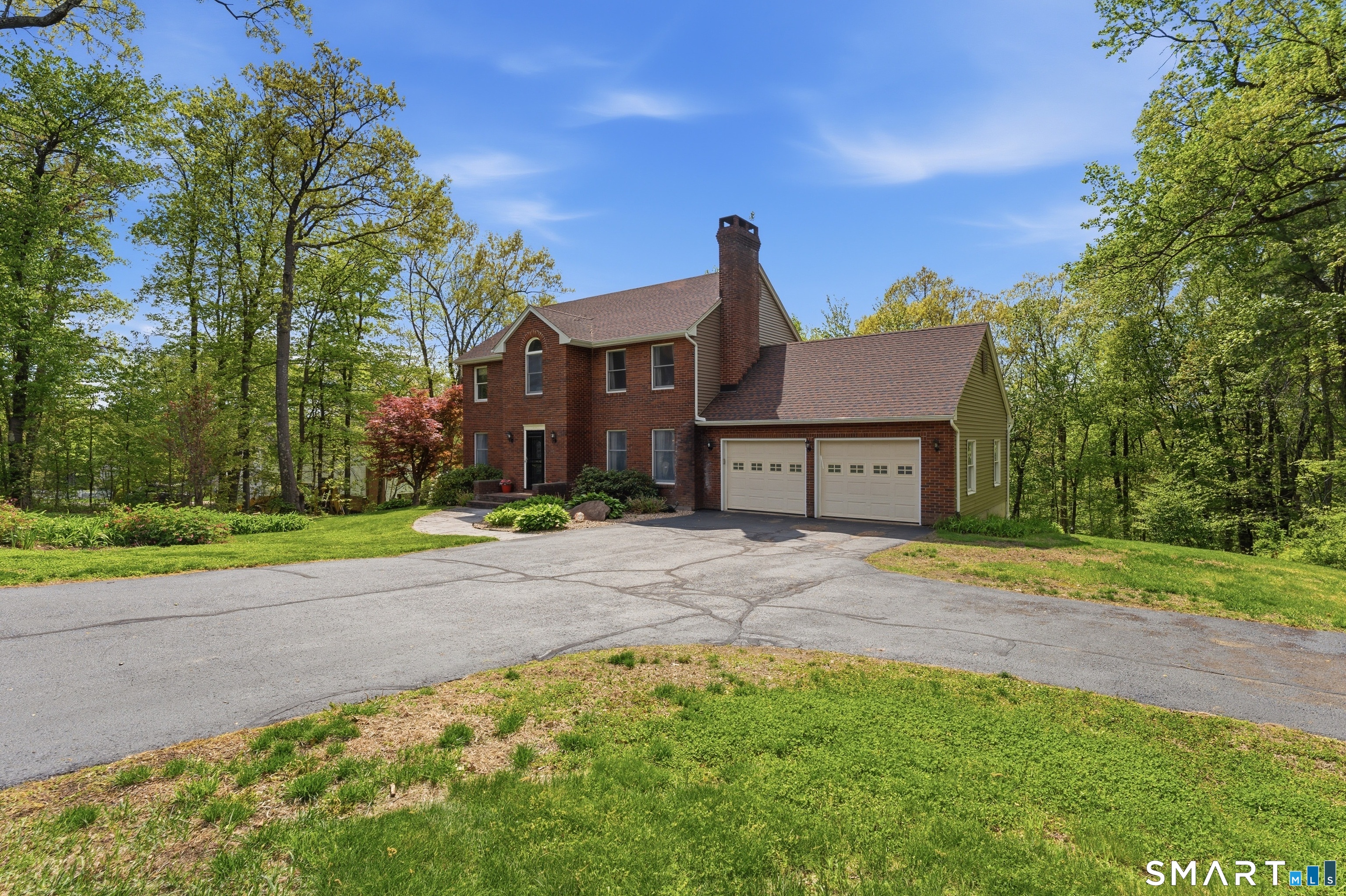 877 Newgate Road Suffield, CT 06093 - Photo 3 of 40 a front view of a house with a yard and garage